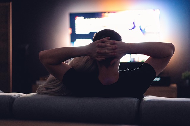 Couple watching TV together in a dark room